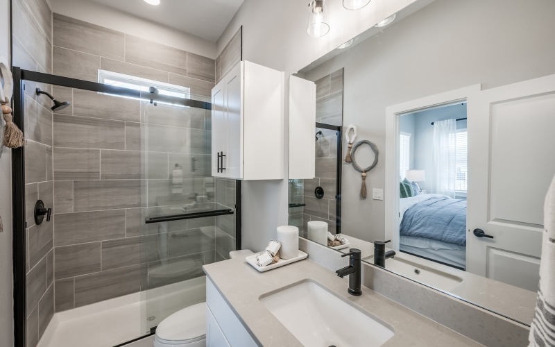 a bathroom with a shower, toilet and sink