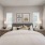 furnished bedroom with windows and walk-in closet
